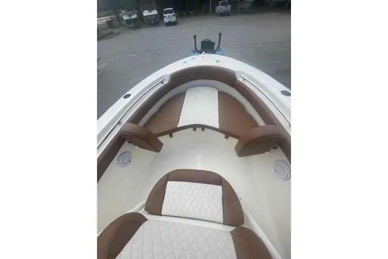 Slide: The Image of 2022 Pioneer 202 Islander boat interior with brown and white cushioned seating. - 6