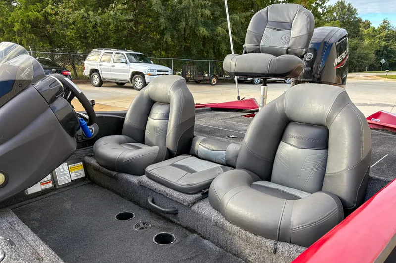 Slide: The Image of 2020 Tracker Pro Team 175 TXW boat interior with gray seating and steering console. - 4