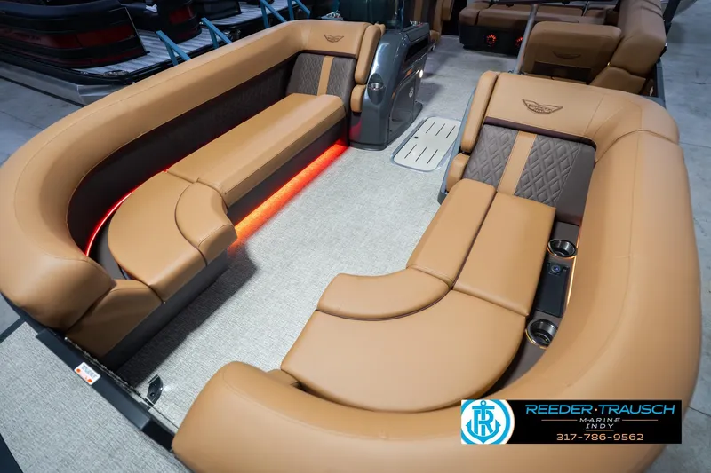 Slide: The Image of Luxurious interior of 2026 Bennington 22 ML pontoon boat with tan seating and ambient lighting. - 12