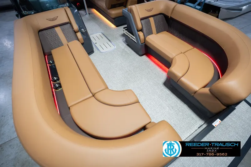 Slide: The Image of Luxurious interior of 2026 Bennington 22 ML pontoon boat with tan seating and ambient lighting. - 13