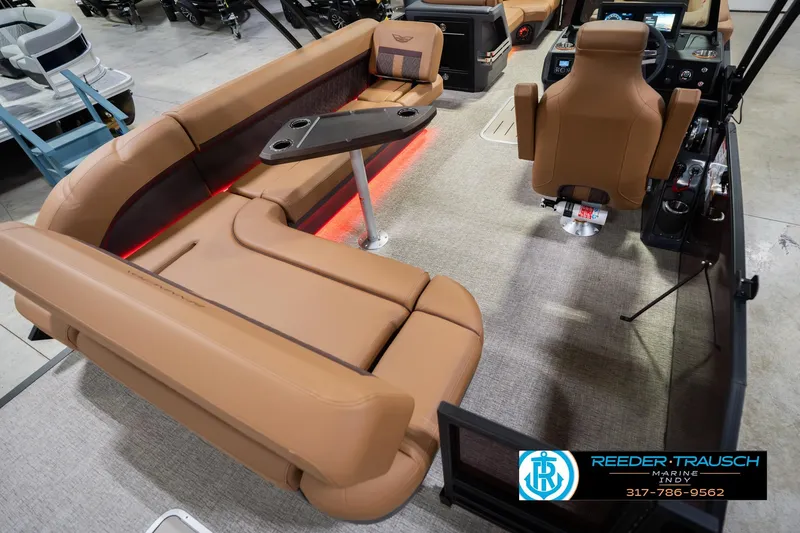 Slide: The Image of 2026 Bennington 22 ML boat interior with tan seating and modern dashboard. - 14