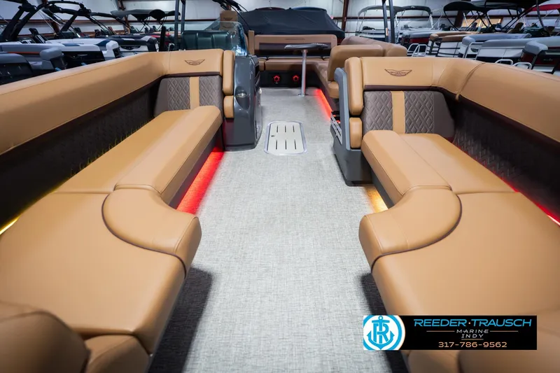 Slide: The Image of Luxurious interior of 2026 Bennington 22 ML pontoon boat with tan seating and ambient lighting. - 16