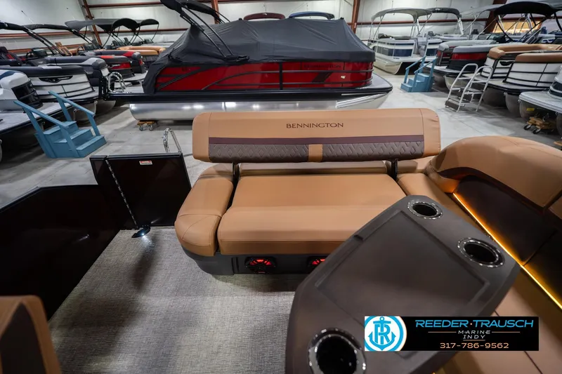 Slide: The Image of 2026 Bennington 22 ML pontoon boat interior with tan seating and cup holders. - 18