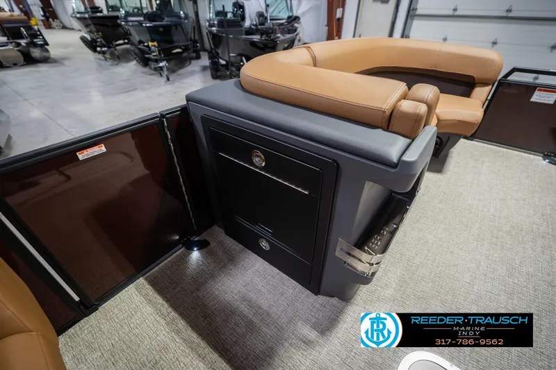 Slide: The Image of 2026 Bennington 22 ML boat interior with tan seating and storage compartment. - 23