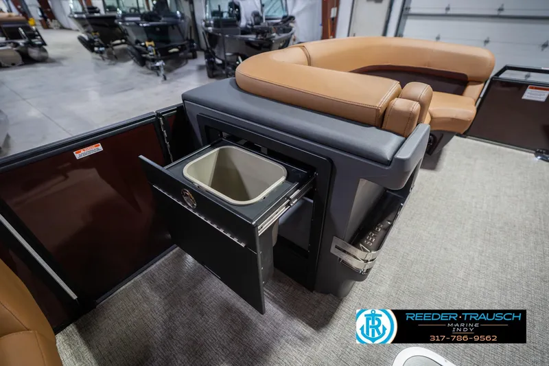 Slide: The Image of 2026 Bennington 22 ML boat interior with tan seating and built-in storage compartment. - 24