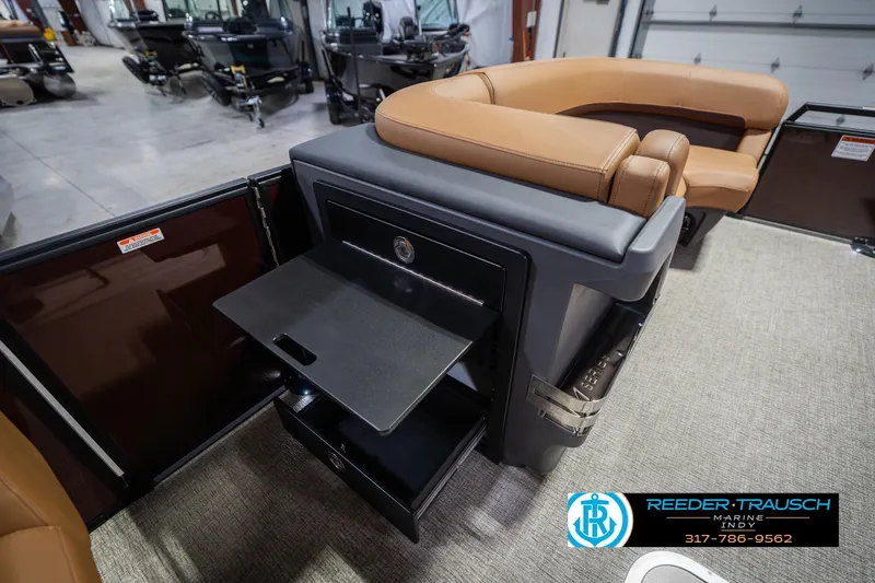 Slide: The Image of 2026 Bennington 22 ML boat interior with tan seating and storage compartments. - 25