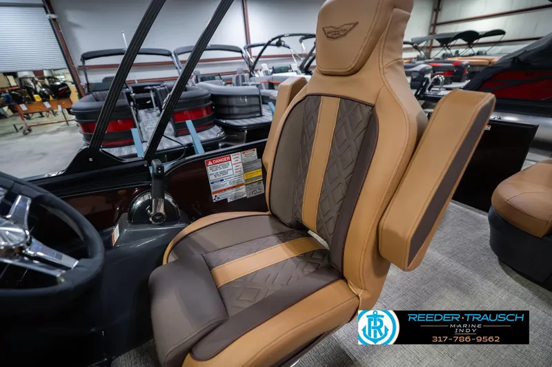 Slide: The Image of 2026 Bennington 22 ML boat seat with luxurious tan and brown upholstery in showroom. - 26