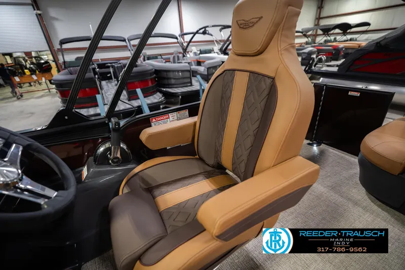 Slide: The Image of 2026 Bennington 22 ML boat interior with luxurious captain's chair in showroom. - 27