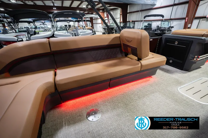 Slide: The Image of Luxurious interior of 2026 Bennington 22 ML pontoon boat with ambient red lighting. - 30