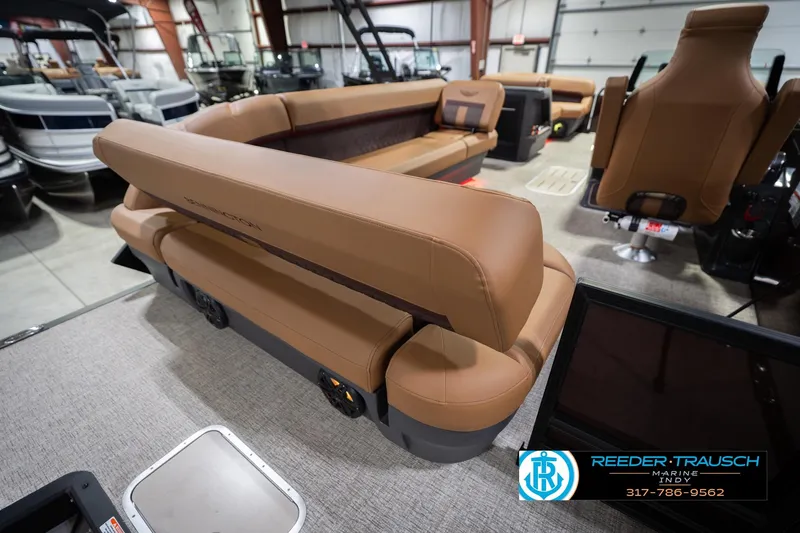 Slide: The Image of 2026 Bennington 22 ML boat interior with tan seating in showroom. - 32