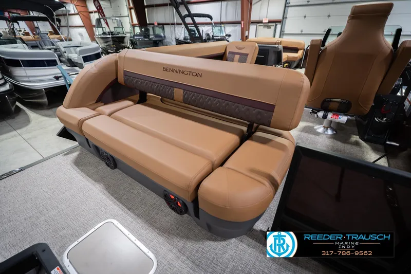 Slide: The Image of 2026 Bennington 22 ML boat interior with tan seating in showroom. - 33