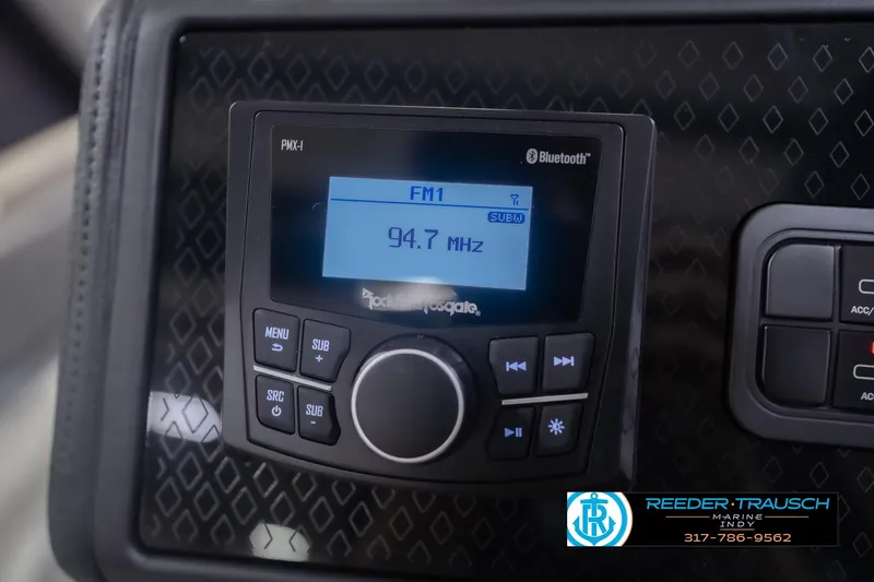 Slide: The Image of 2026 Bennington 22 ML boat stereo system displaying FM radio at 94.7 MHz. - 38
