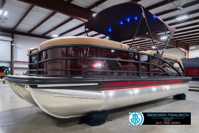 Slide: The Image of 2026 Bennington 22 ML pontoon boat in showroom with canopy and sleek design. - 4