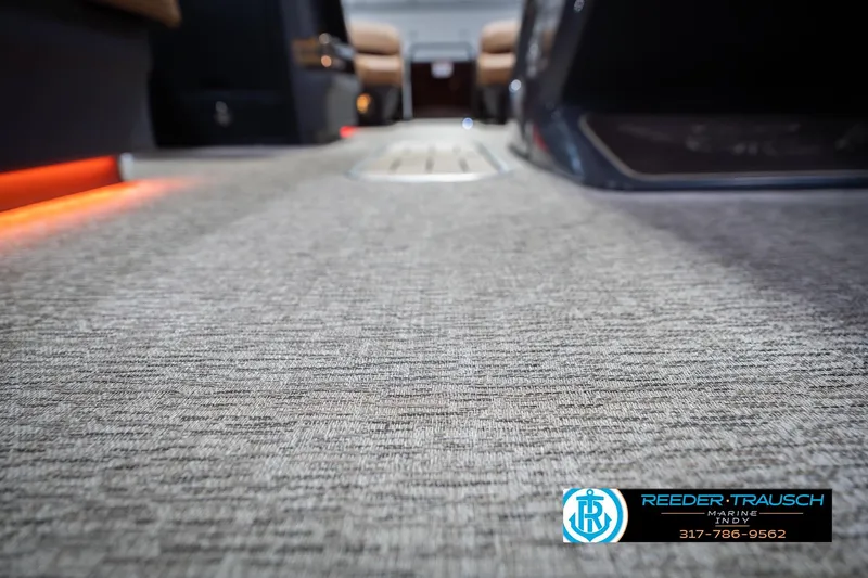 Slide: The Image of 2026 Bennington 22 ML boat interior with textured flooring and ambient lighting. - 52