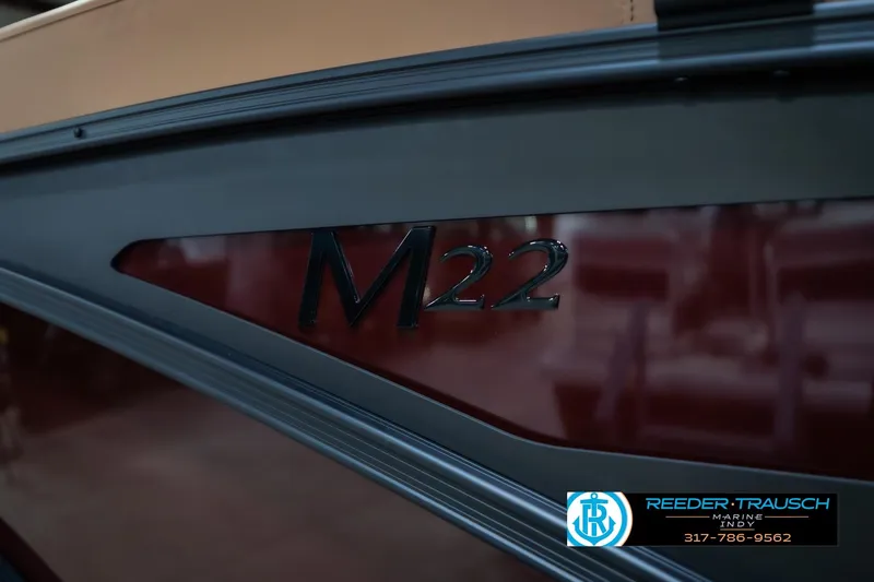 Slide: The Image of 2026 Bennington 22 ML boat with M22 logo, Reeder-Trausch Marine branding. - 55