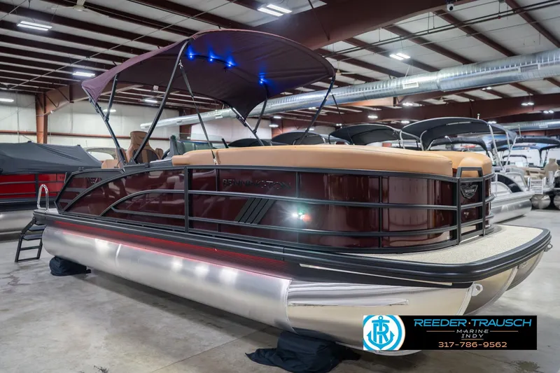Slide: The Image of 2026 Bennington 22 ML pontoon boat in showroom with canopy and sleek design. - 6