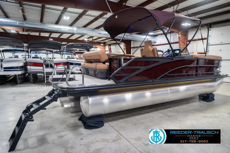 Slide: The Image of 2026 Bennington 22 ML pontoon boat in showroom with canopy and seating. - 8
