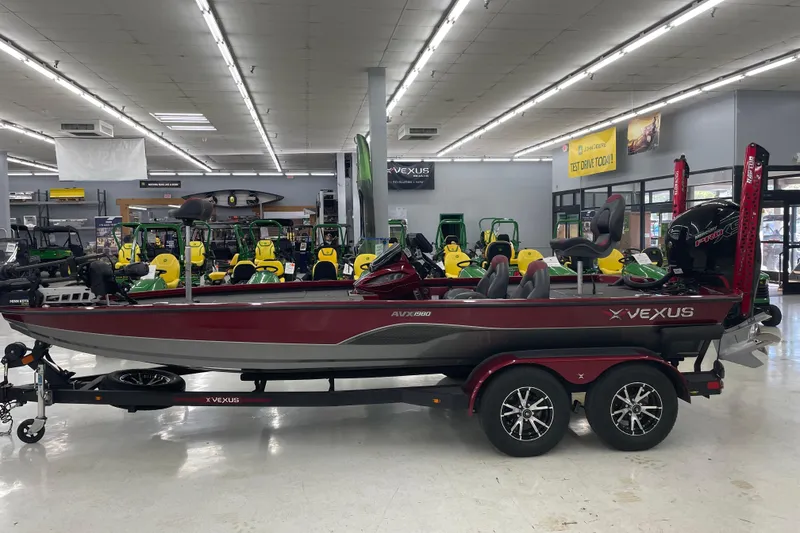 Slide: The Image of 2023 Vexus AVX1980 boat displayed in showroom with John Deere equipment. - 0