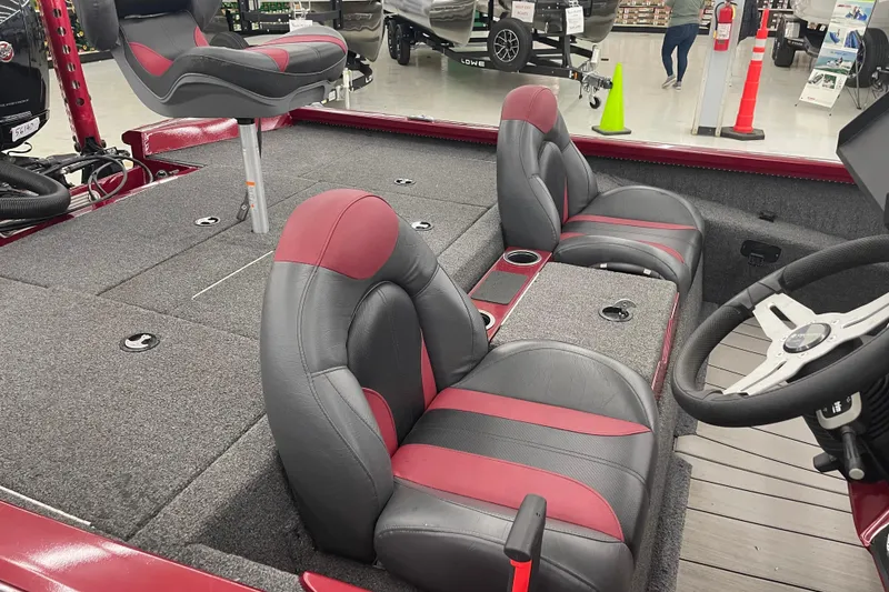 Slide: The Image of 2023 Vexus AVX1980 boat interior with red and gray seating, steering wheel, and carpeted deck. - 10