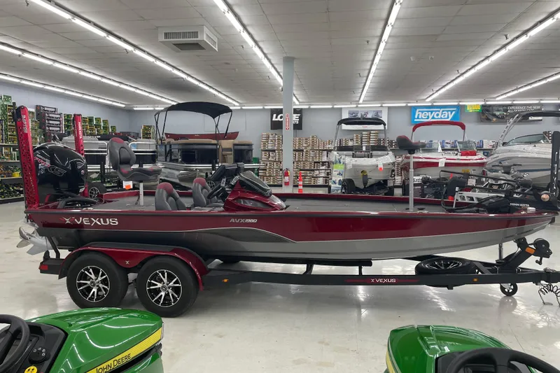 Slide: The Image of 2023 Vexus AVX1980 boat displayed in a showroom with various equipment and accessories. - 2