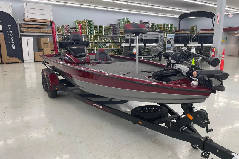 Slide: The Image of 2023 Vexus AVX1980 boat in showroom, red and gray design, on trailer. - 3