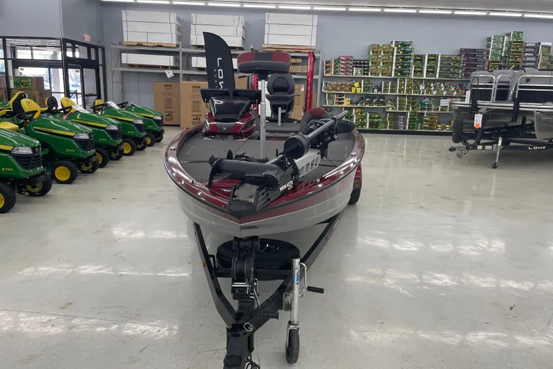 Slide: The Image of 2023 Vexus AVX1980 boat displayed indoors, surrounded by lawn tractors and equipment. - 4