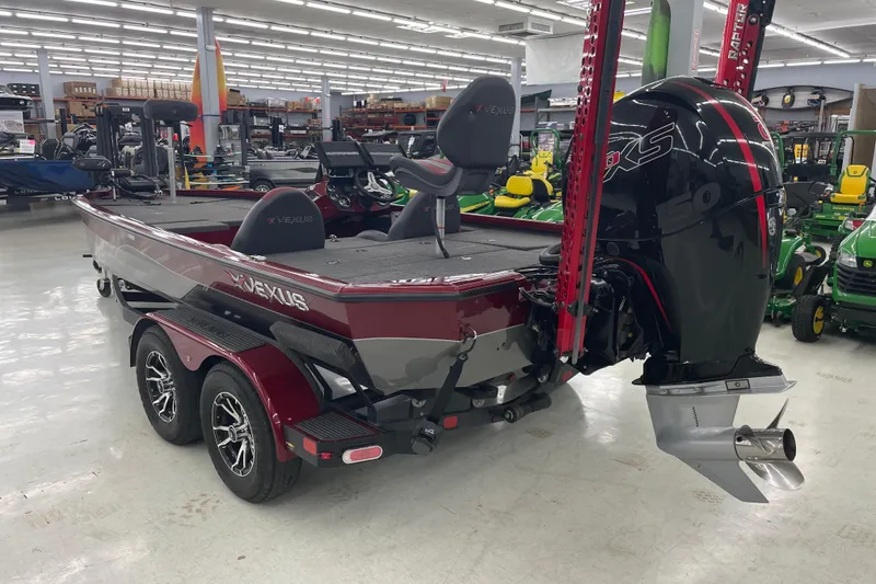 Slide: The Image of 2023 Vexus AVX1980 boat with powerful outboard motor in showroom setting. - 7