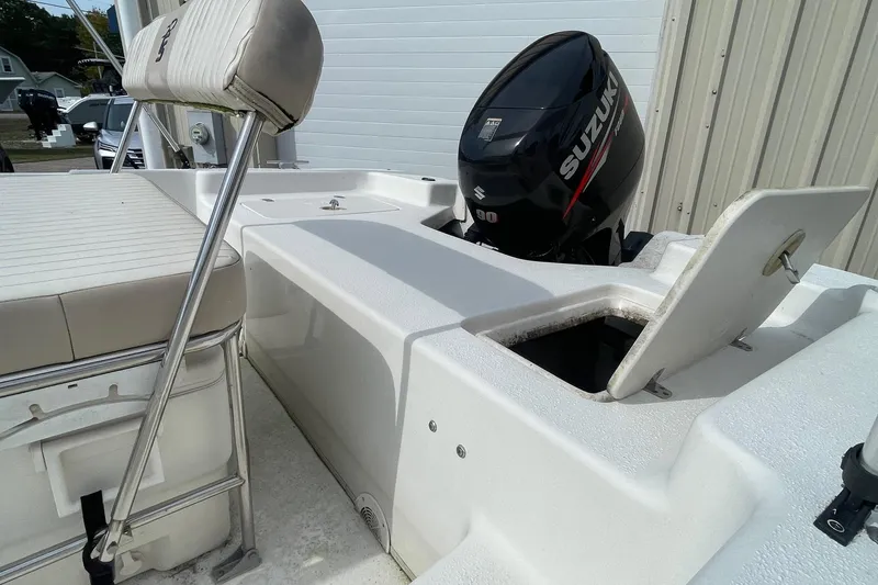 Slide: The Image of 2016 Carolina Skiff 178 DLX boat with Suzuki outboard motor and open storage compartment. - 10