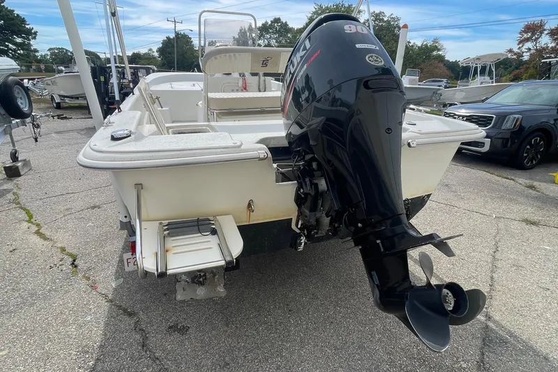 Slide: The Image of 2016 Carolina Skiff 178 DLX boat with Suzuki outboard motor, parked on a lot. - 3