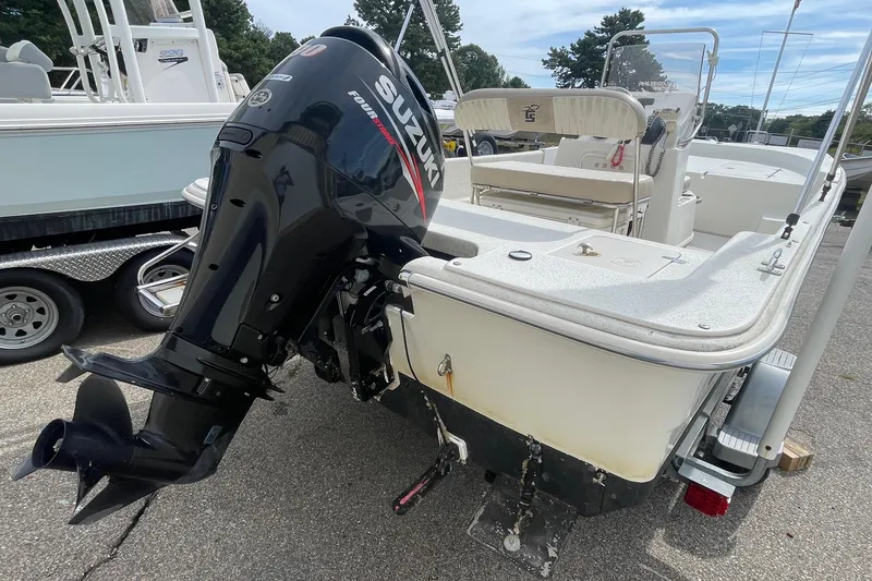 Slide: The Image of 2016 Carolina Skiff 178 DLX boat with Suzuki outboard motor, parked on a trailer. - 4