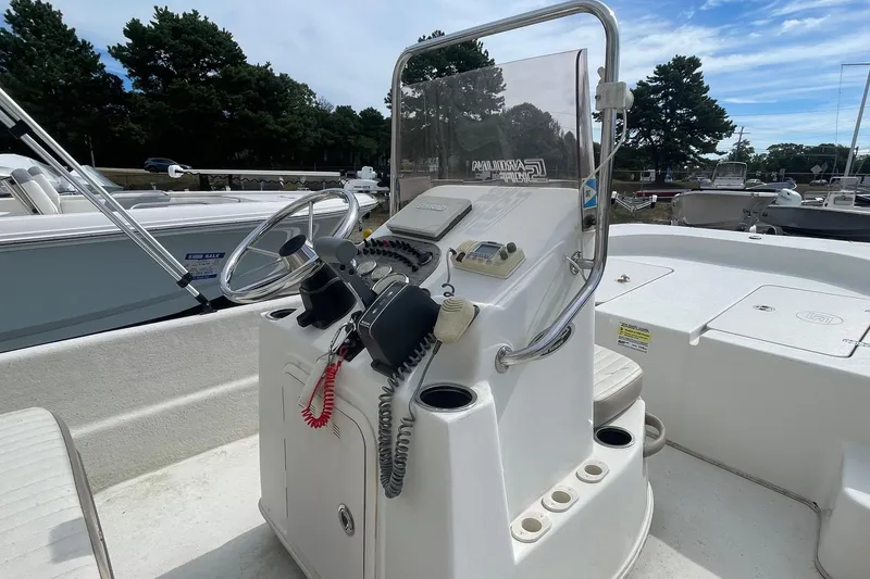Slide: The Image of 2016 Carolina Skiff 178 DLX boat console with steering wheel and controls. - 6