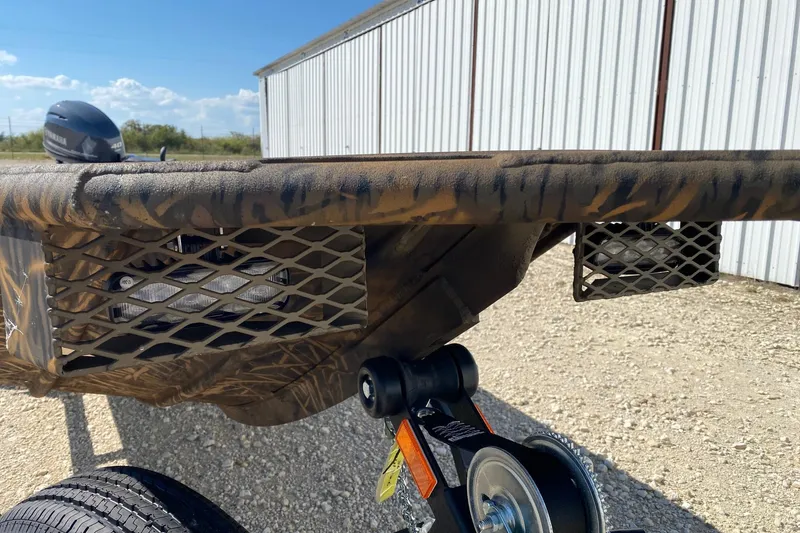 Slide: The Image of 2026 G3 16DK boat with camouflage design and Yamaha motor, parked outdoors. - 2