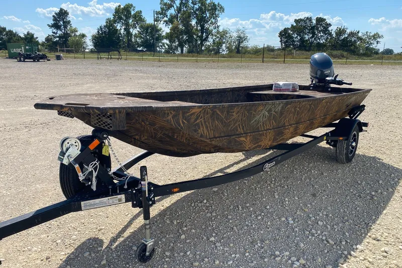 Slide: The Image of 2026 G3 16DK boat on trailer, camo design, parked outdoors. - 3