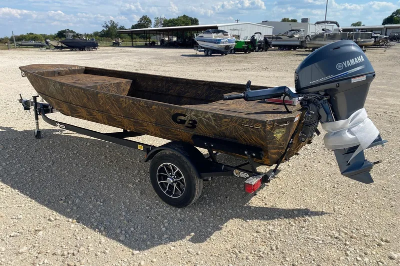 Slide: The Image of 2026 G3 16DK boat with Yamaha motor on a trailer in a gravel lot. - 6