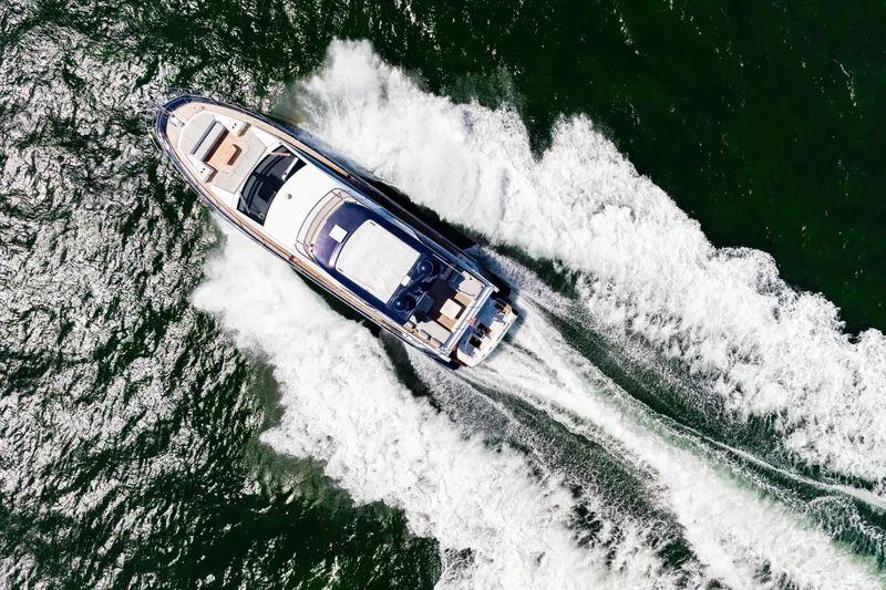 Slide: The Image of Aerial view of 2020 Azimut 60 Fly yacht cruising on open water. - 11