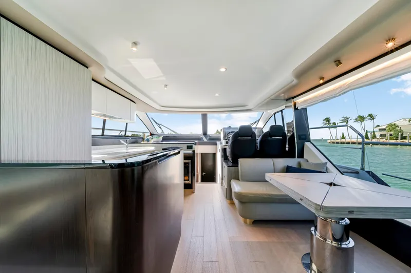 Slide: The Image of Luxurious interior of 2020 Azimut 60 Fly yacht with modern seating and panoramic windows. - 23