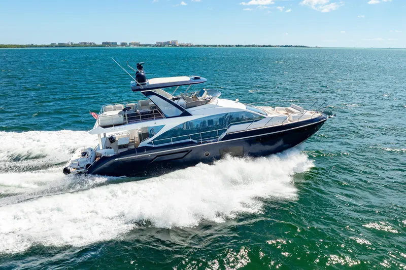 Slide: The Image of 2020 Azimut 60 Fly yacht cruising on open water under clear skies. - 3