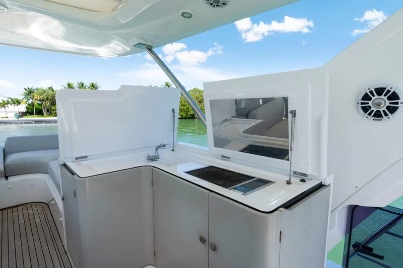 Slide: The Image of Luxurious Azimut 60 Fly 2020 yacht with sleek outdoor kitchen and scenic water view. - 47