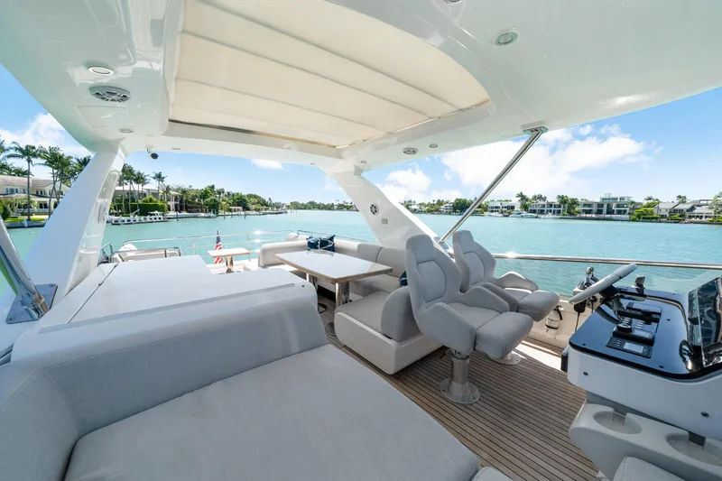 Slide: The Image of Luxurious 2020 Azimut 60 Fly yacht interior with plush seating and scenic waterfront view. - 50