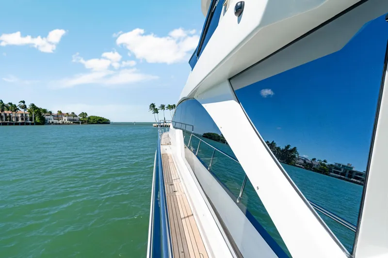 Slide: The Image of 2020 Azimut 60 Fly yacht cruising on a sunny day, reflecting blue skies and water. - 51