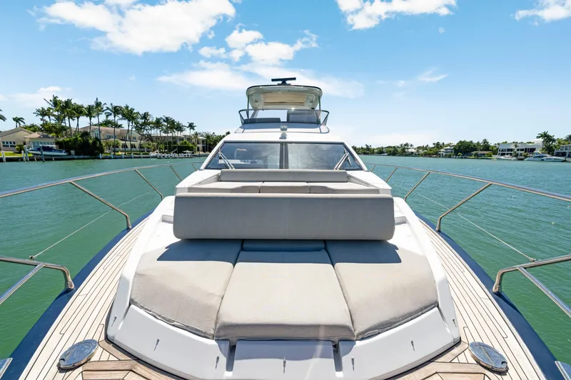 Slide: The Image of Luxurious 2020 Azimut 60 Fly yacht on serene water, featuring spacious sunbathing area. - 54