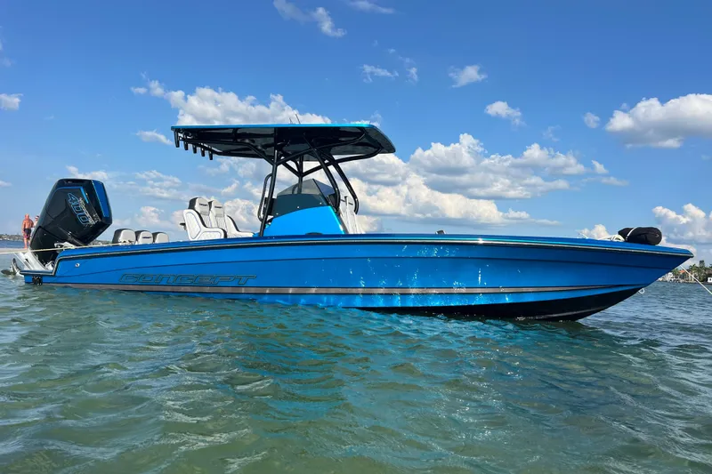 Slide: The Image of 2025 Concept 27' Open Deck boat in blue on calm water under a clear sky. - 2