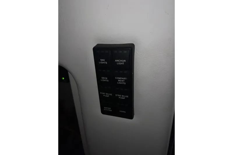 Slide: The Image of Control panel on 2025 Concept 27' Open Deck boat, featuring various light and pump switches. - 21