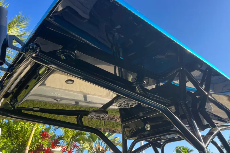 Slide: The Image of Sleek black canopy of 2025 Concept 27' Open Deck boat under clear blue sky. - 25