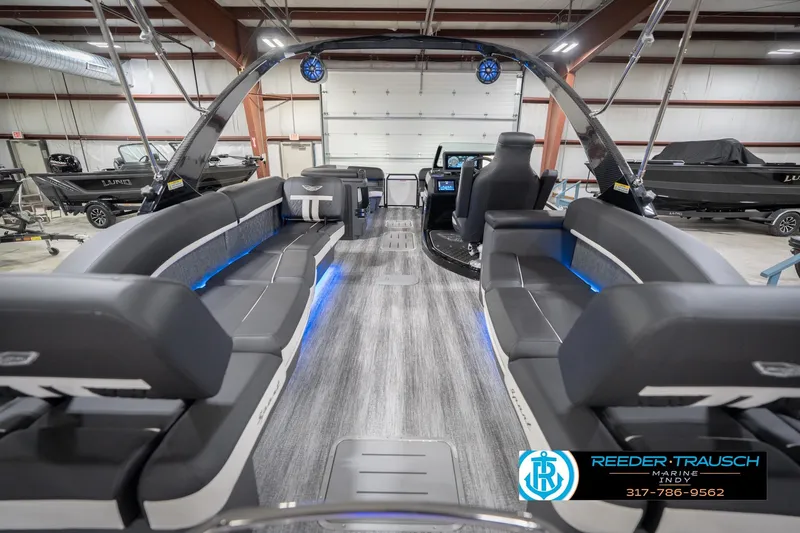 Slide: The Image of 2026 Bennington 24 MSL pontoon boat interior with sleek seating and modern design in a showroom. - 19