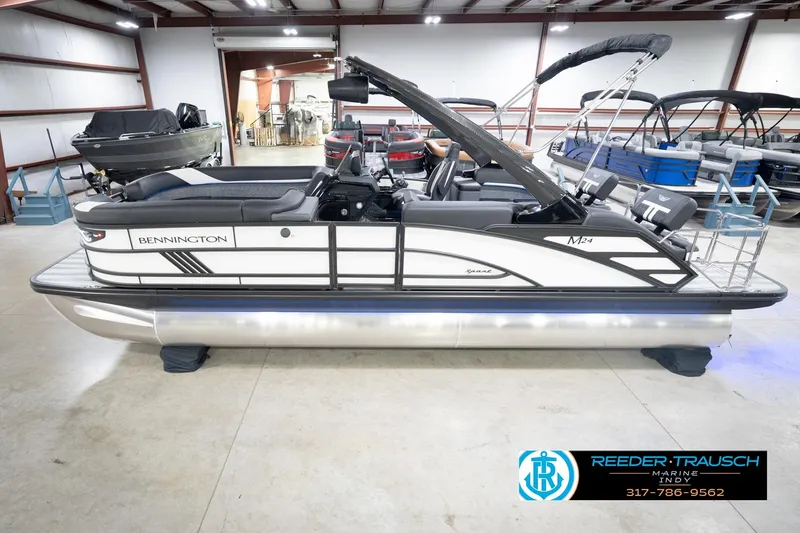 The Image of 2026 Bennington 24 MSL pontoon boat displayed indoors at Reeder-Trausch Marine showroom. - 2