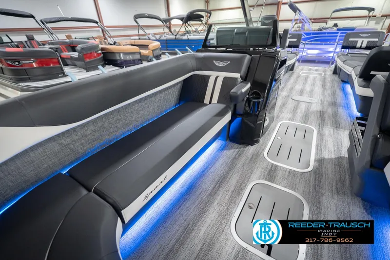 Slide: The Image of 2026 Bennington 24 MSL pontoon boat interior with sleek seating and ambient blue lighting. - 23