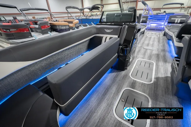 Slide: The Image of 2026 Bennington 24 MSL pontoon boat interior with blue LED lighting and modern seating. - 24