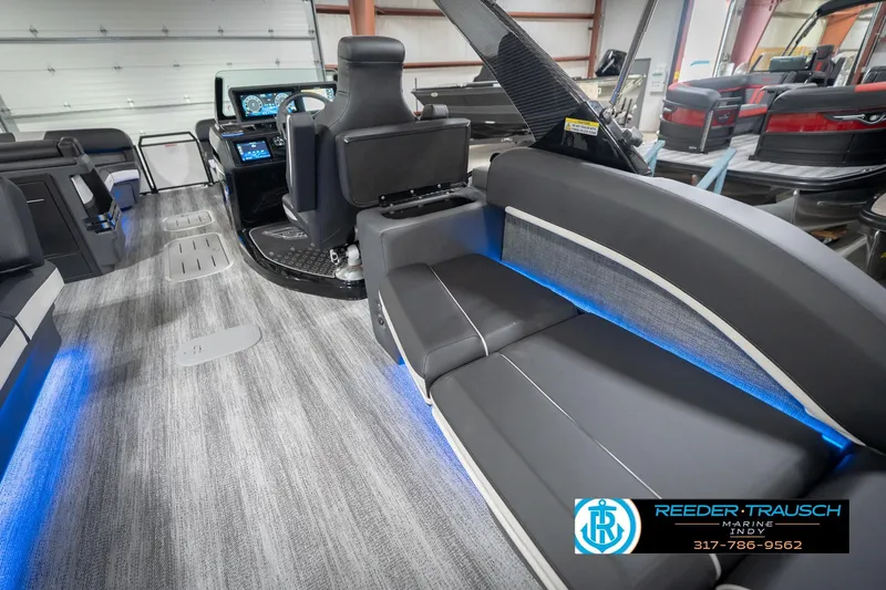 Slide: The Image of Interior of 2026 Bennington 24 MSL boat with modern seating and blue LED lighting. - 31