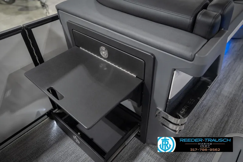 Slide: The Image of 2026 Bennington 24 MSL boat interior with pull-out table and storage compartment. - 36